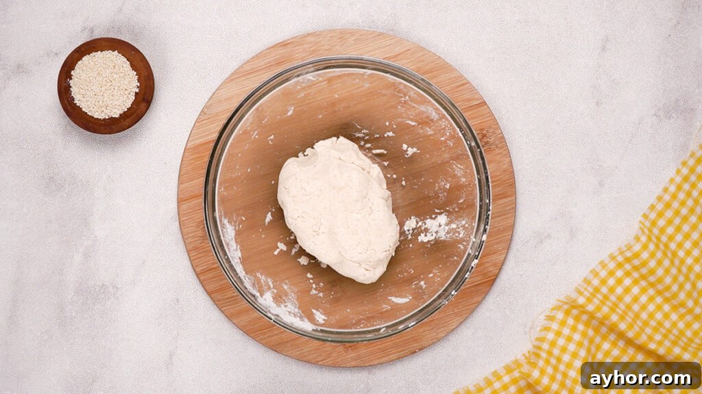 A ball of gluten-free cracker dough has formed in the mixing bowl, ready to be rolled out and shaped.