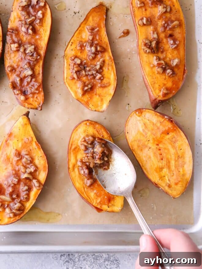Adding maple pecan sauce to the roasted sweet potatoes