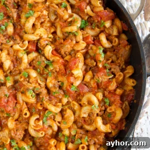 Classic American Goulash Recipe: Hearty One-Pot Comfort Meal 7 A large black skillet is filled with cooked goulash.