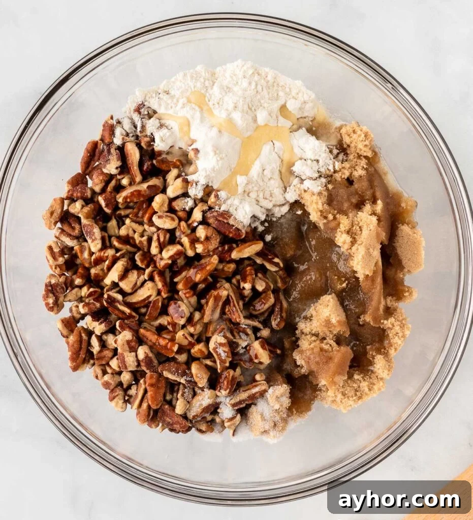 Creamy Sweet Potato Casserole with Toasted Marshmallows 12 pecan crumble ingredients in a mixing bowl