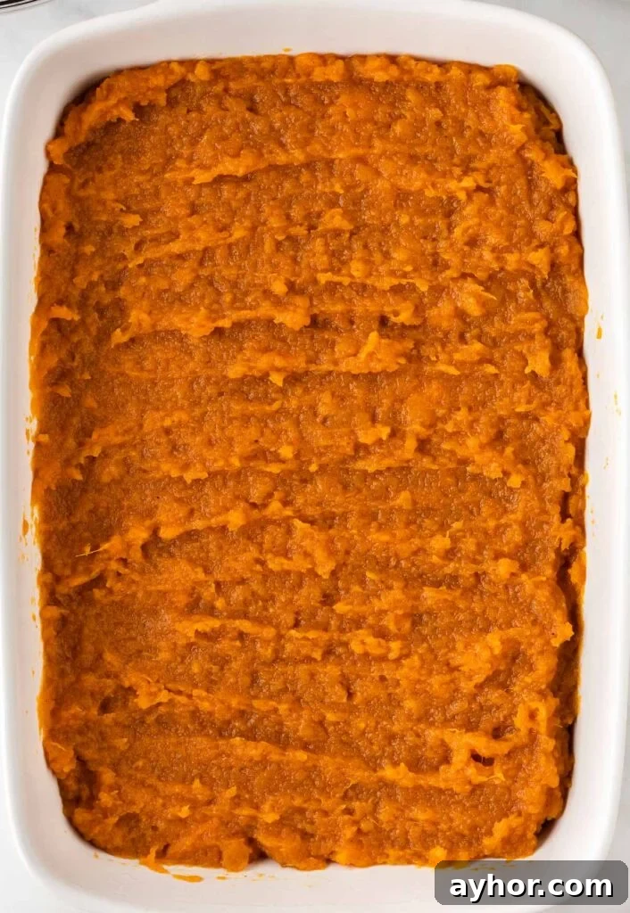 Creamy Sweet Potato Casserole with Toasted Marshmallows 14 sweet potato casserole filling in a baking dish