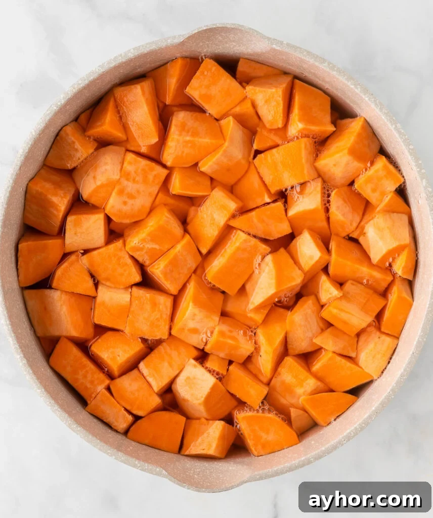 Creamy Sweet Potato Casserole with Toasted Marshmallows 6 sweet potatoes being boiled in water