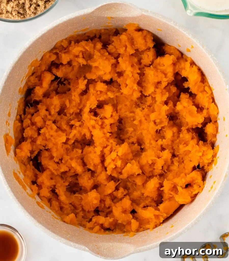 Creamy Sweet Potato Casserole with Toasted Marshmallows 9 mashed sweet potatoes in a sauce pan