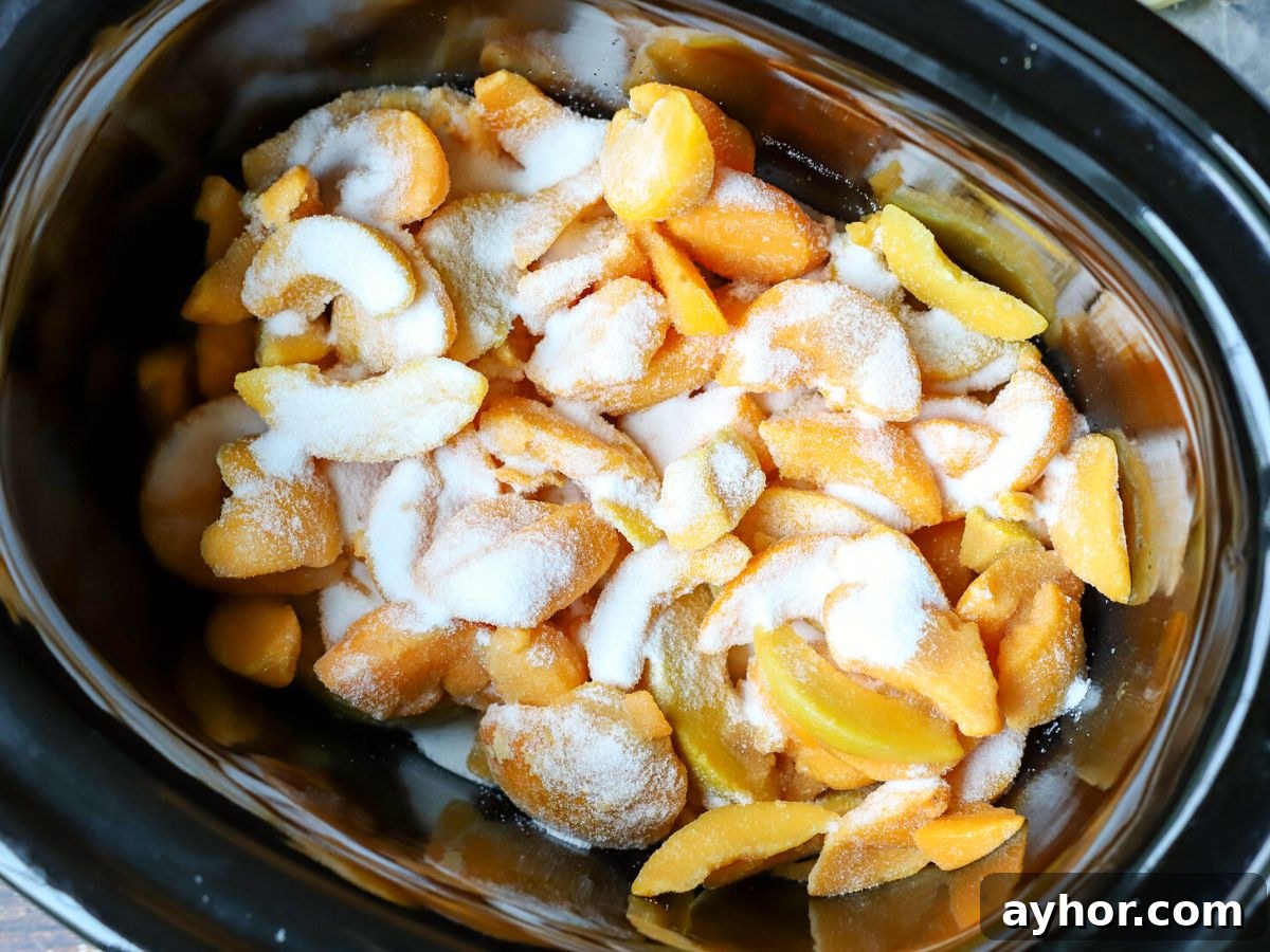 Slow-Cooker Peach Cobbler Recipe: Juicy Homemade Dessert 4 peaches and sugar in a crock pot.