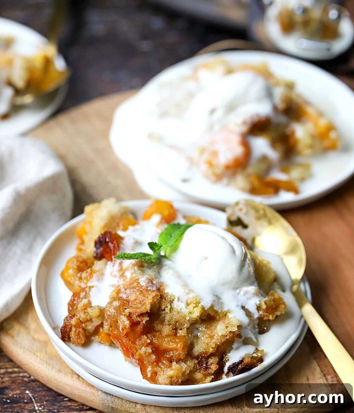 Slow-Cooker Peach Cobbler Recipe: Juicy Homemade Dessert 9 peach cobbler on a plate with melting ice cream.