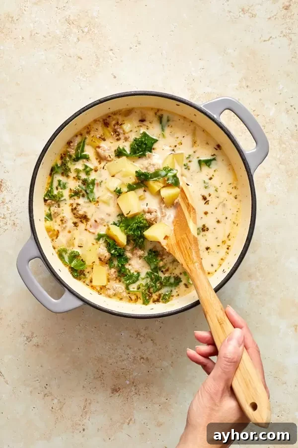 A dutch oven filled with No Dairy Zuppa Toscana.