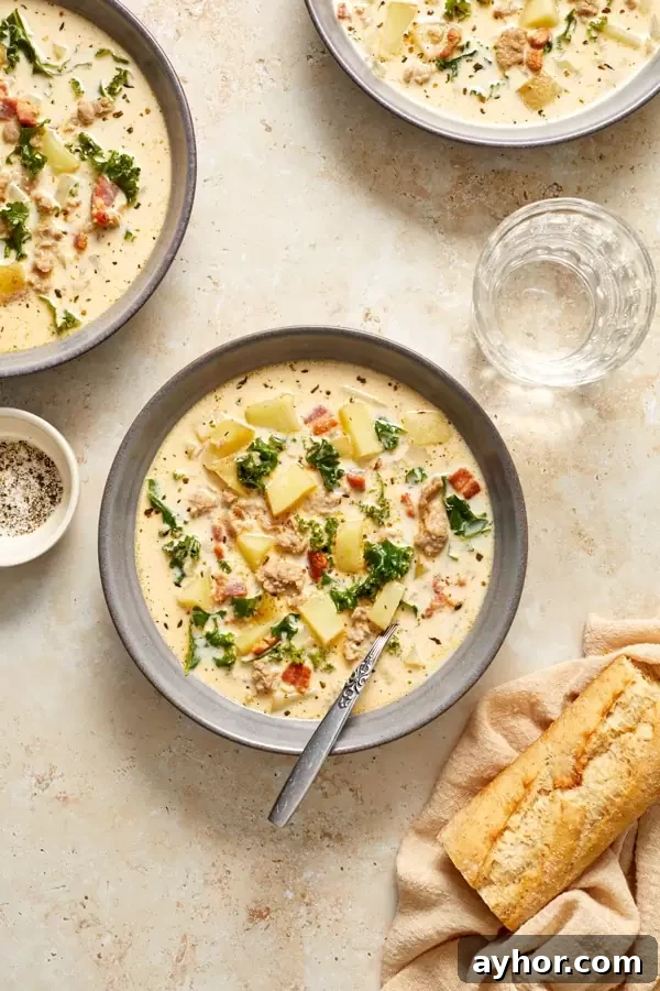 Three grey bowls filled with Dairy Free Gluten Free Zuppa Toscana.