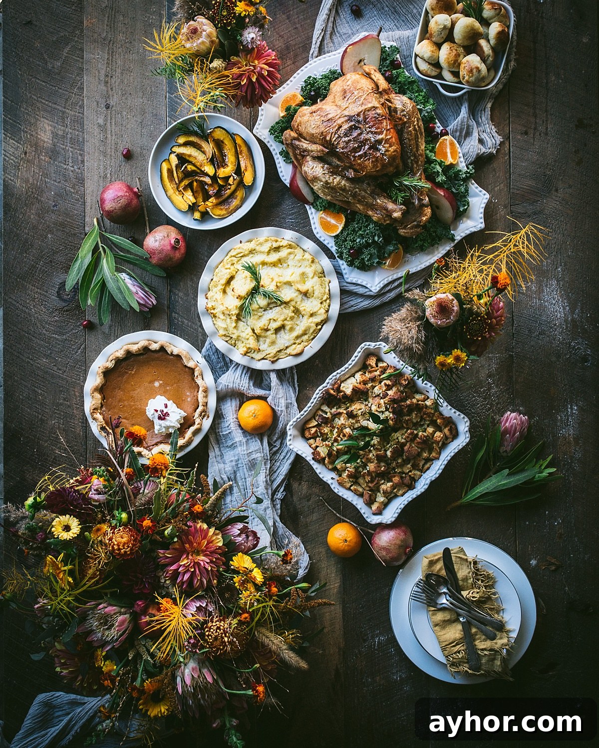 17 Global Thanksgiving Recipes for a Non-Traditional Feast 2 moody flatlay of thanksgiving dishes such as turkey, stuffing, potatoes, pumpkin pie, squash, and rolls