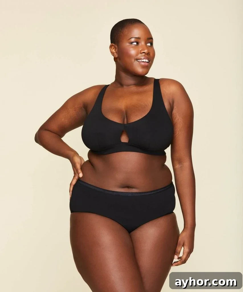 a woman wearing a black, plus size organic and natural underwear from Knickey