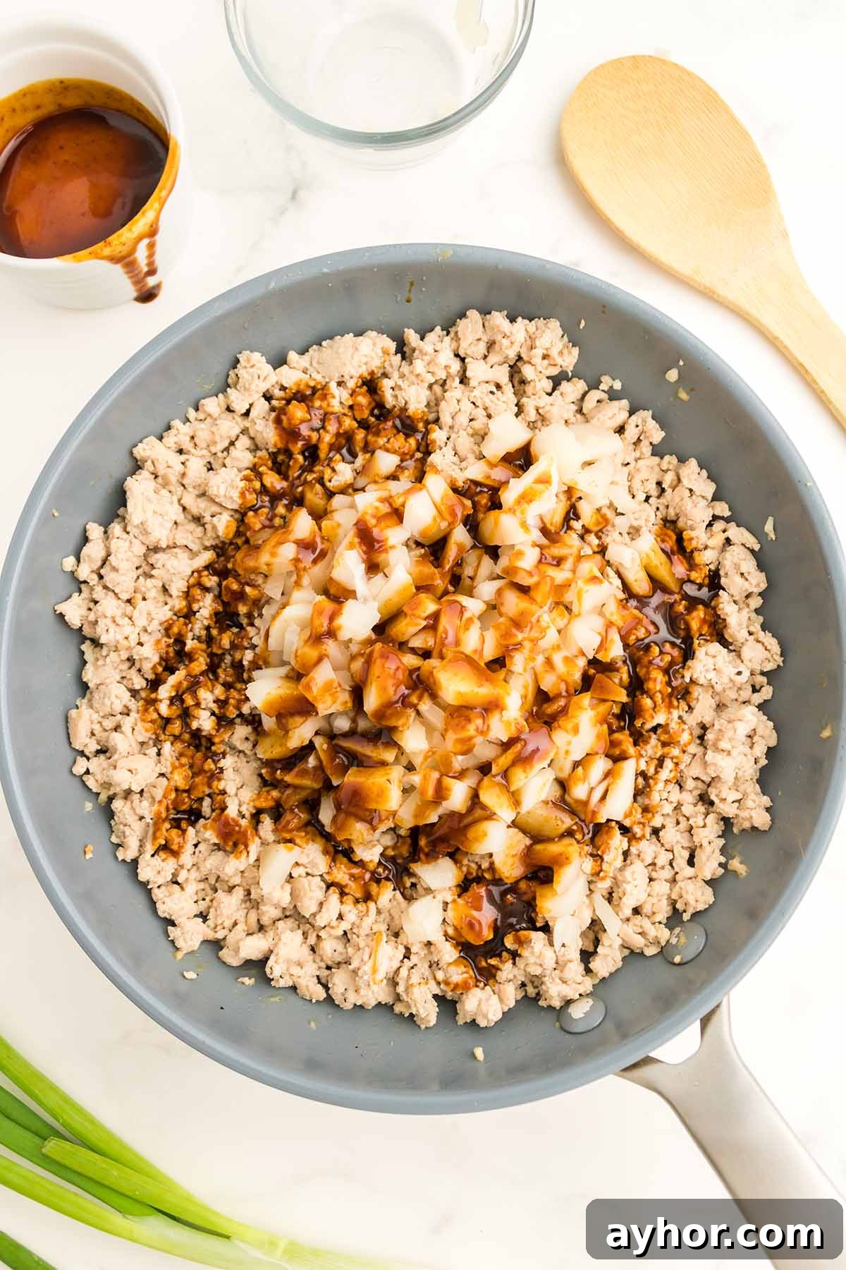 Savory Chicken Lettuce Wraps Recipe with Ginger and Soy 4 Ground chicken with sauce in a skillet.