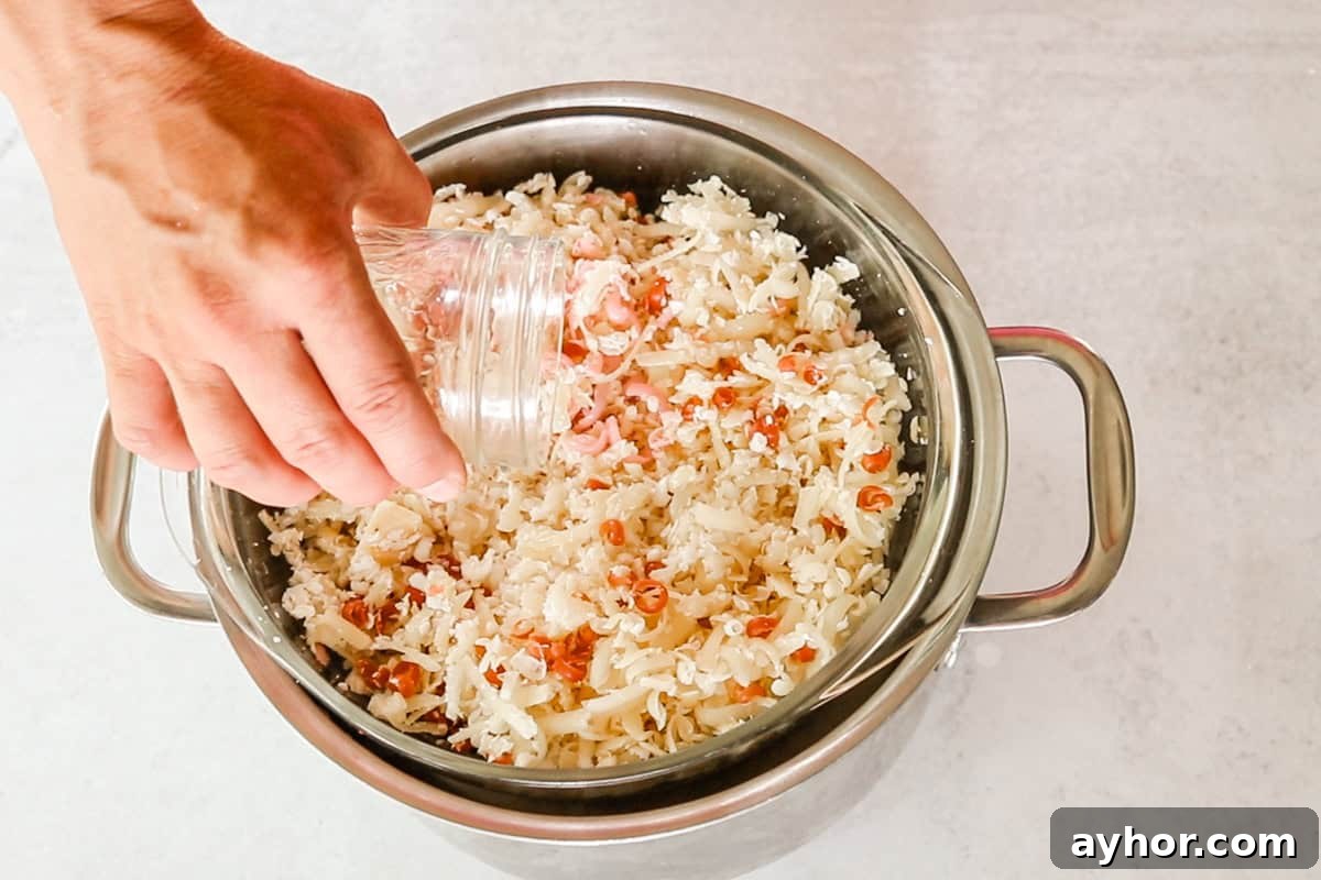 Adding water to shaved soap scraps in a double boiler.
