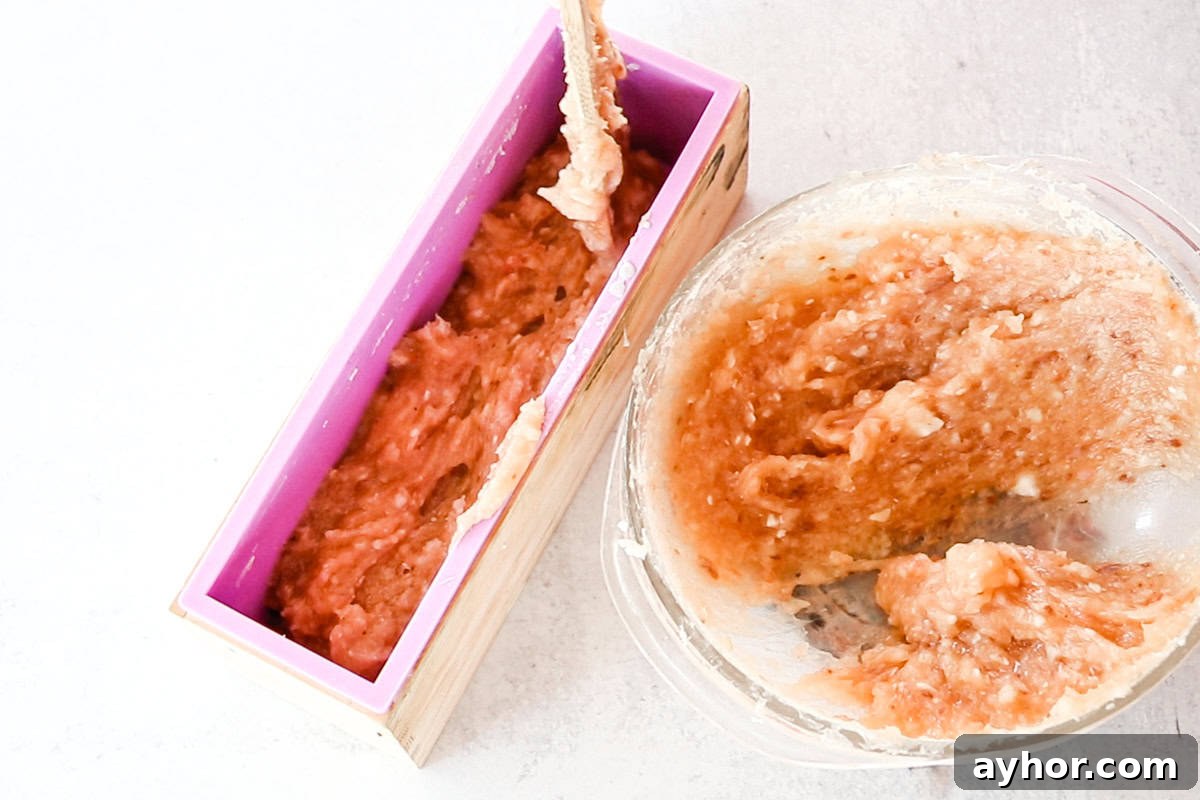 Scooping the melted rebatch soap into a large loaf soap mold.