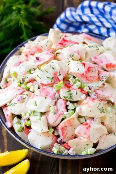 Creamy crab salad with fresh vegetables and dill in a mayonnaise dressing.