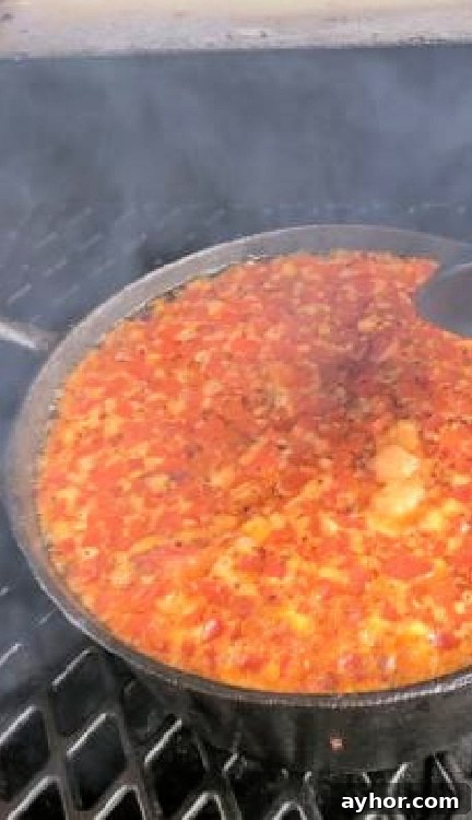 Dutch oven with pulled pork chili on a pellet grill