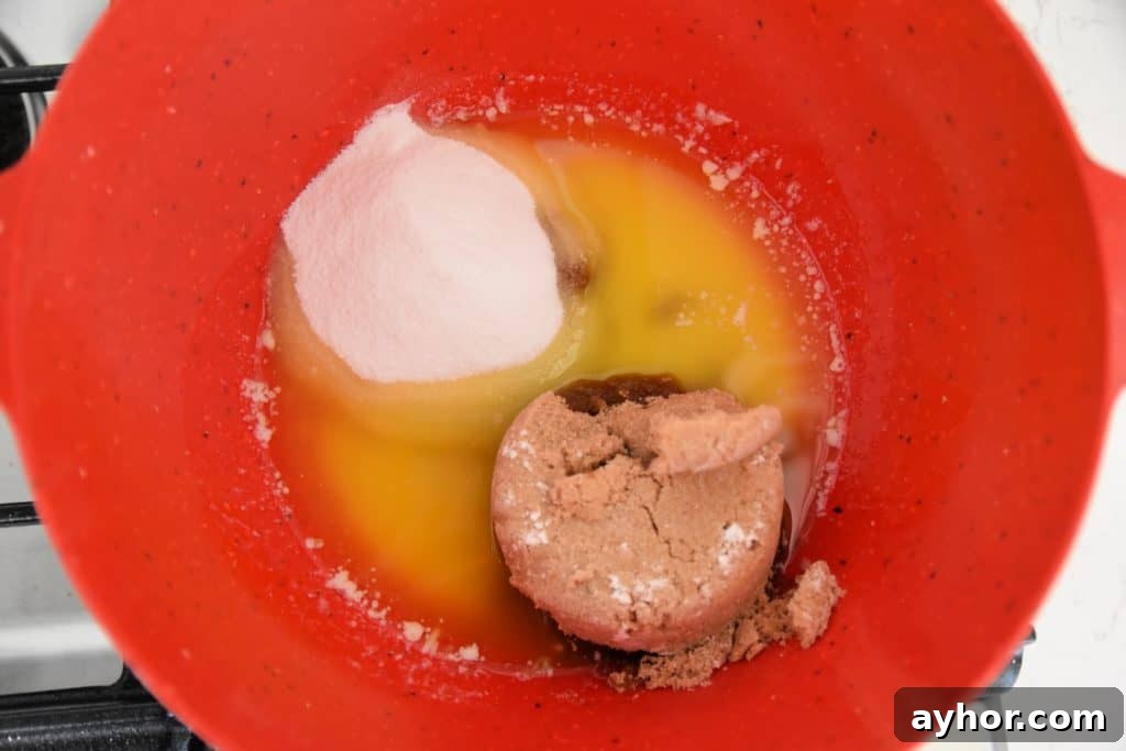 Easter Blondie Bars with Marshmallow Eggs Recipe 5 sugar and melted butter in a red bowl