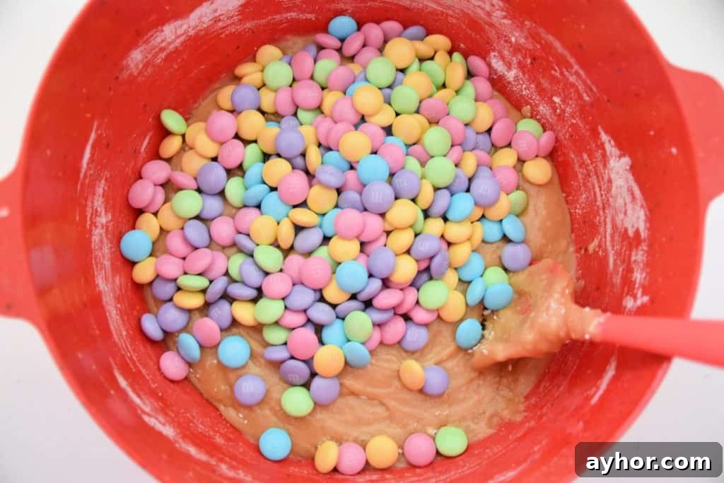 Easter Blondie Bars with Marshmallow Eggs Recipe 7 pastel m&ms in batter in red bowl