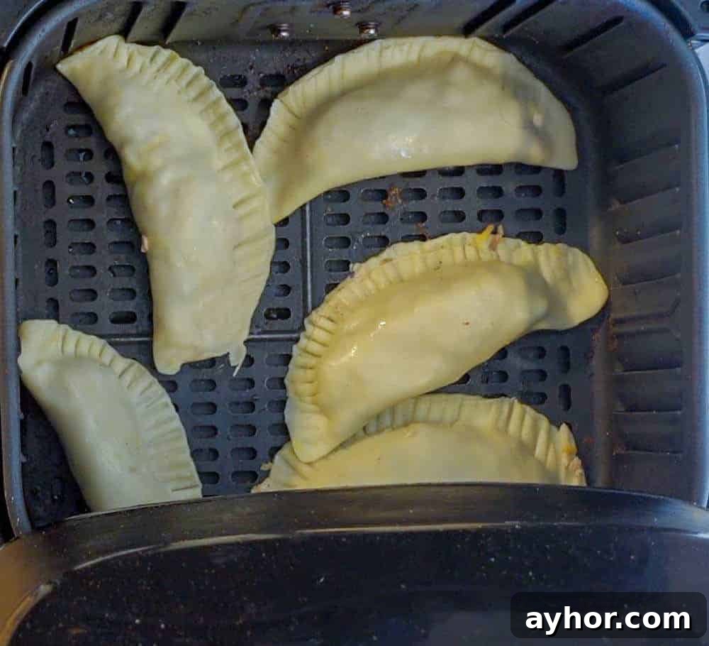 Crispy Air Fryer Empanadas Recipe — Homemade and Flavorful 6 empanadas in air fryer before cooking