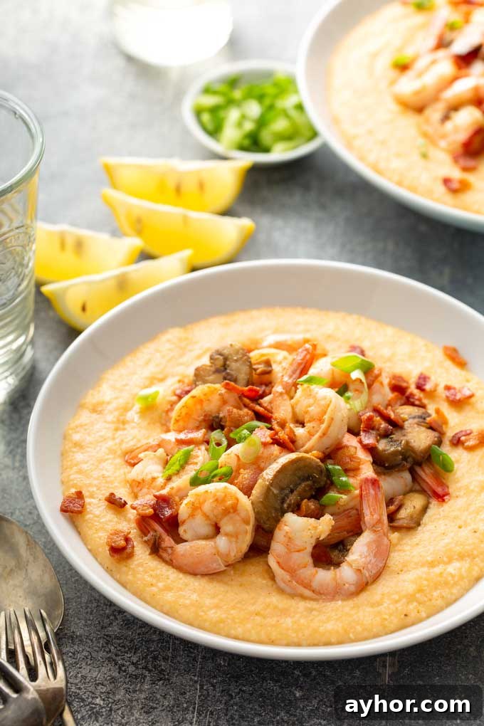 Cajun Shrimp and Grits: Creamy Southern Comfort Recipe 2 Bowls filled with cheesy grits and topped with shrimp,
