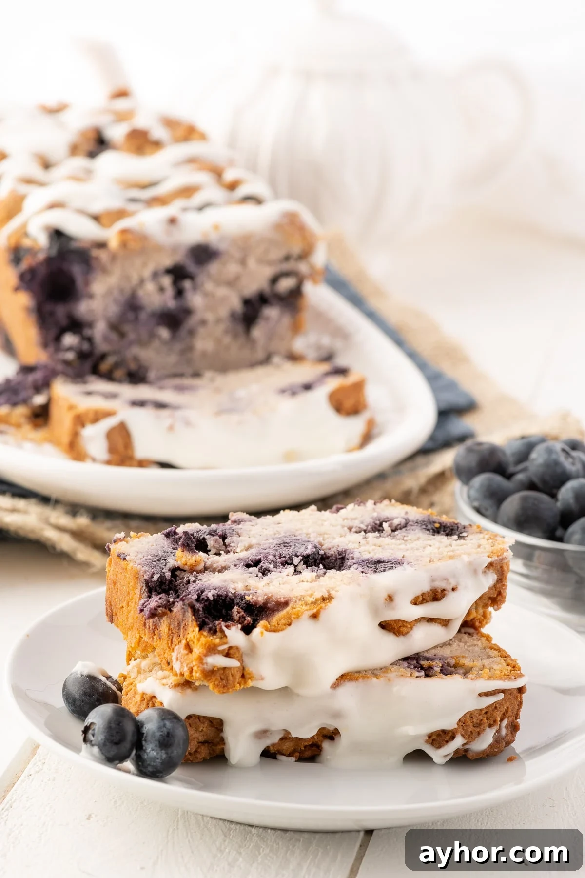 Low-Carb Keto Blueberry Bread with Zesty Lemon Drizzle 6 Low carb blueberry loaf served on a plate.