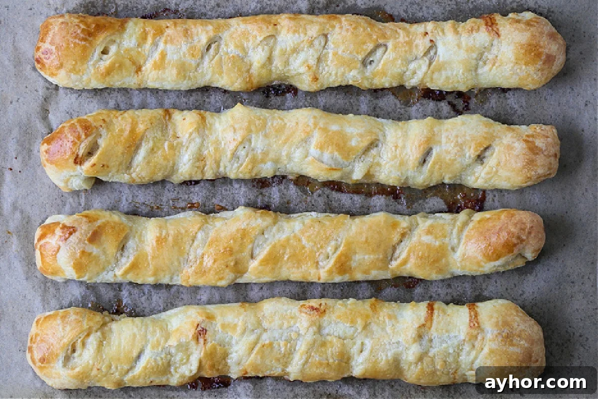 Everyone loves Puff Pastry Sausage Rolls! A buttery, flaky crust with a cheesy sausage filling. Perfect for holidays, parties and game days! baked puff pastry filled with sausage and cheese