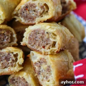 cut sausage rolls stacked on plate