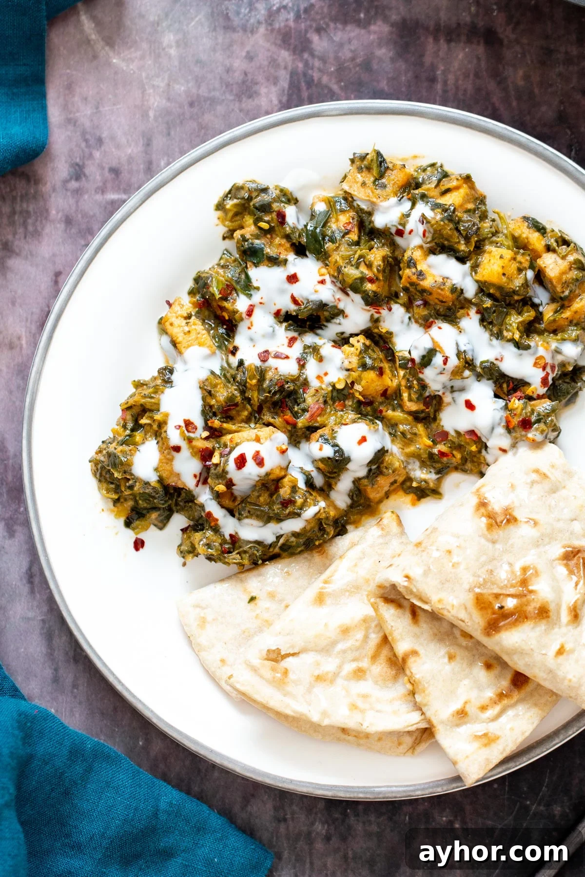 spicy Indian tofu spinach stirfry served with a side of flatbread 