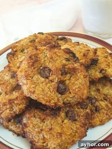 A plate of banana cornflake breakfast cakes with a glass of milk.
