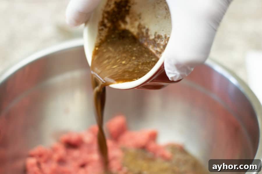 Coconut-Infused Ground Beef Jerky 5 pouring marinade into ground meat