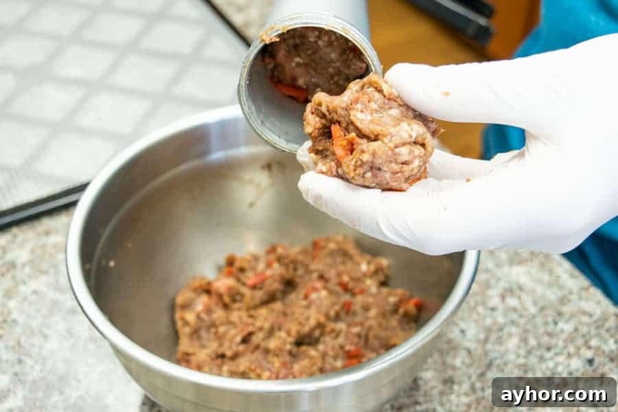 Coconut-Infused Ground Beef Jerky 7 loading jerky gun with ground meat