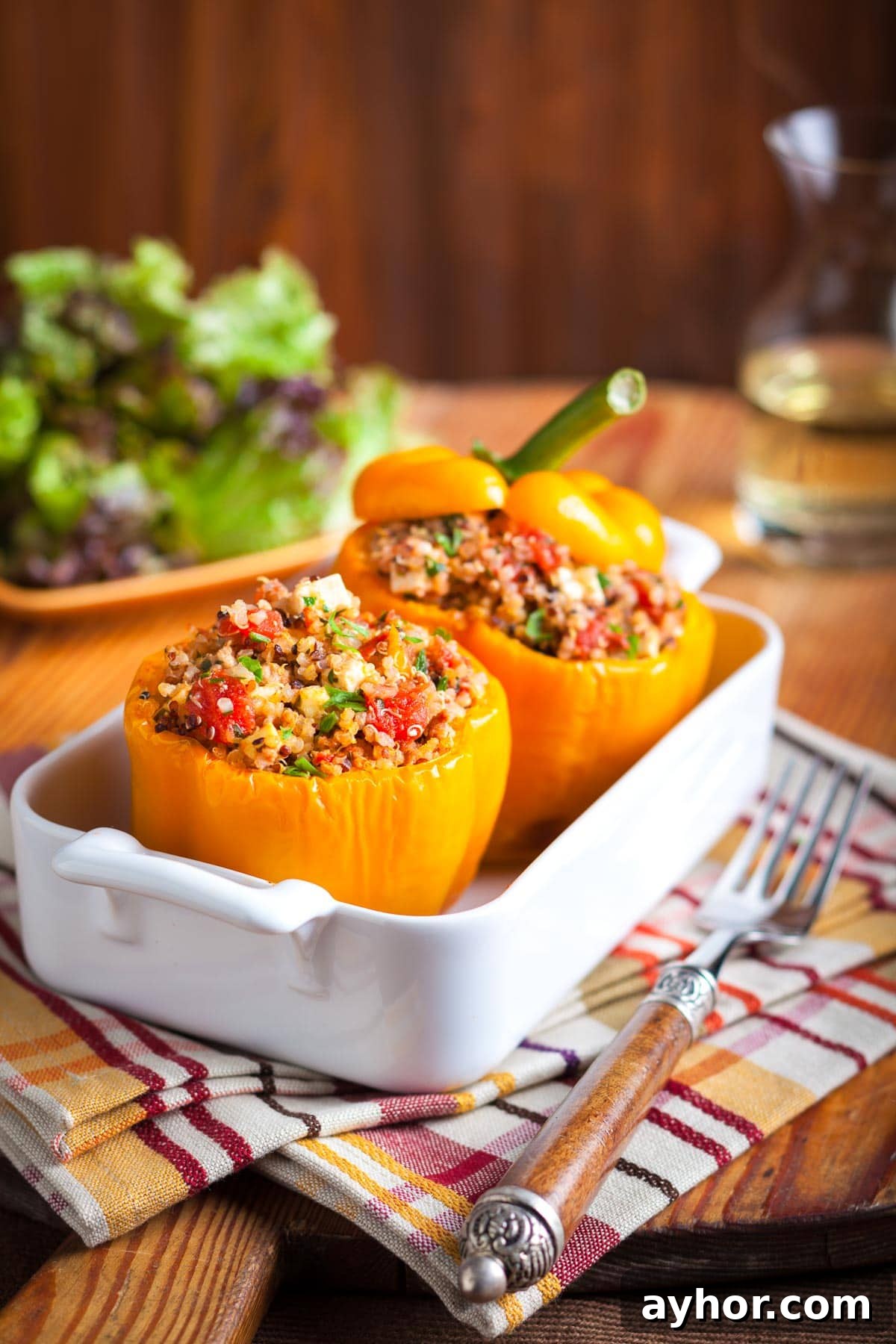 Ground Turkey Stuffed Peppers with Savory Tomato Rice 10 Ground turkey stuffed orange bell peppers in a white casserole dish.
