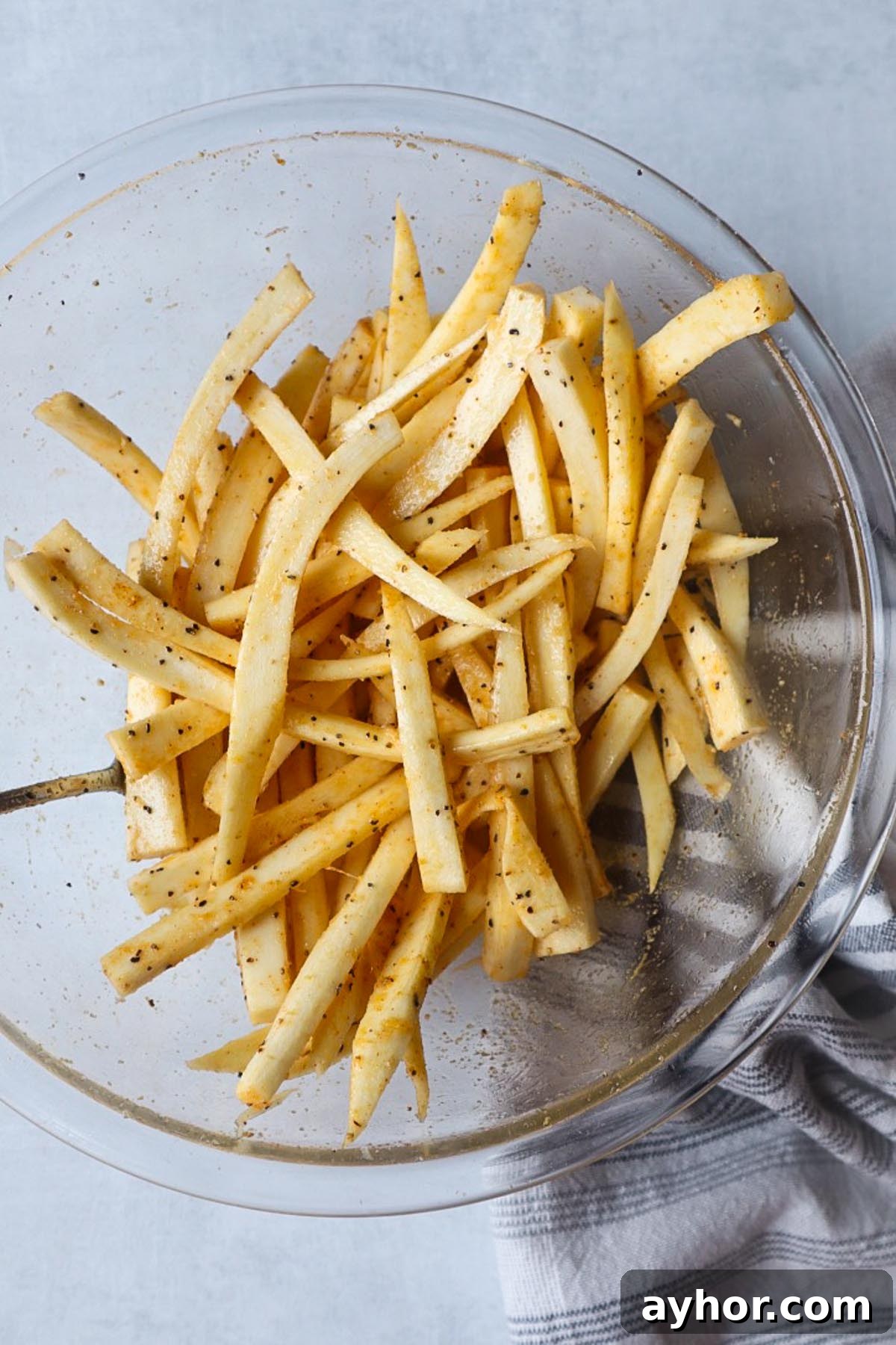 Crispy Air Fryer Roasted Parsnips Recipe 3 glass bowl with chopped seasoned parsnips