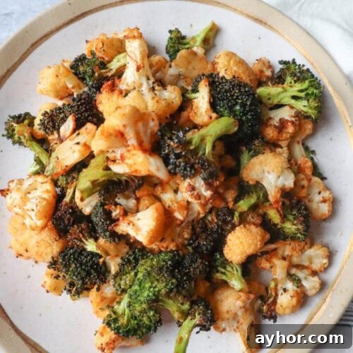 air fried broccoli and cauliflower seasoned on a plate