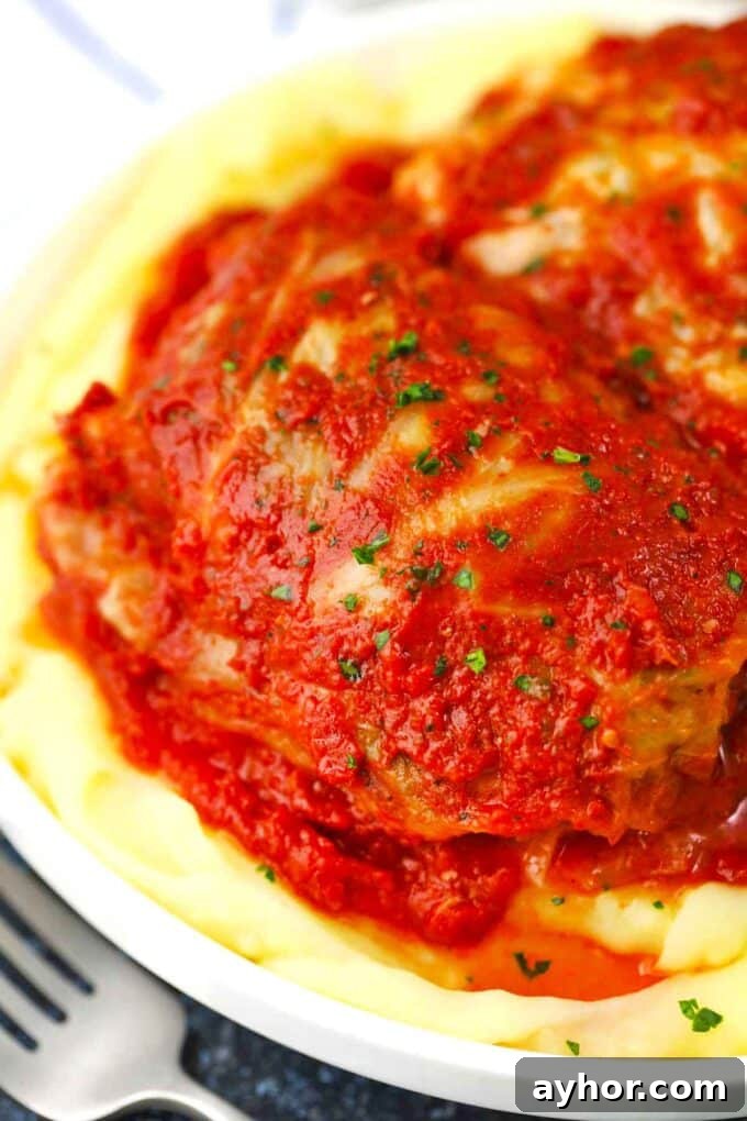 Comforting Stuffed Cabbage Rolls with Savory Tomato Sauce 12 homemade stuffed cabbage rolls served with mashed potatoes