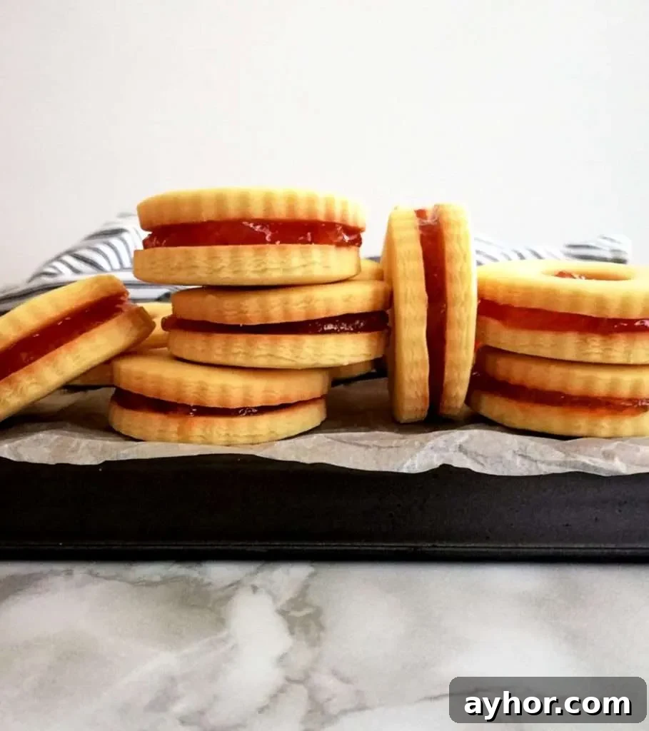apricot jam filled sandwich cookies on baking sheet head on view
