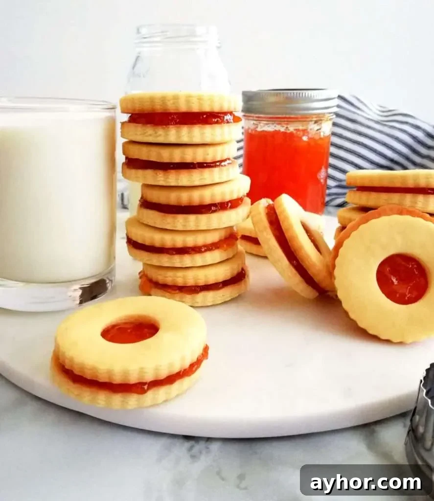apricot jam filled sandwich cookies on serving board