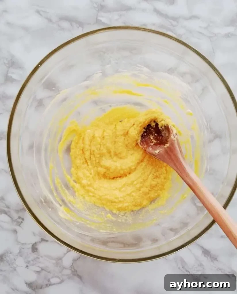 apricot jam filled sandwich cookies butter, sugar, egg yolks, and vanilla mixed together in bowl