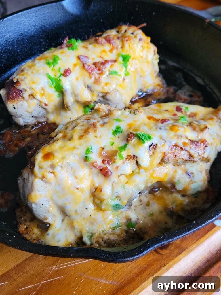 Jalapeño Popper Stuffed Chicken Breast with Creamy Cheese Filling 12 cheesy jalapeno stuffed chicken breast in a cast iron pan