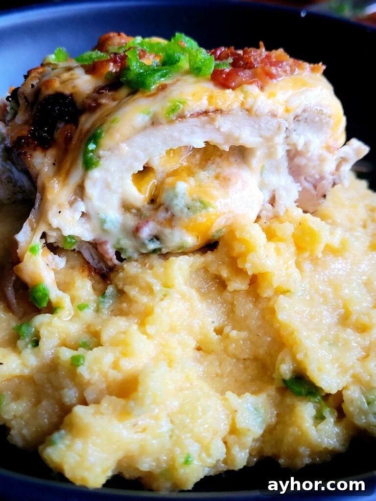Jalapeño Popper Stuffed Chicken Breast with Creamy Cheese Filling 3 jalapeno popper chicken on a bed of polenta