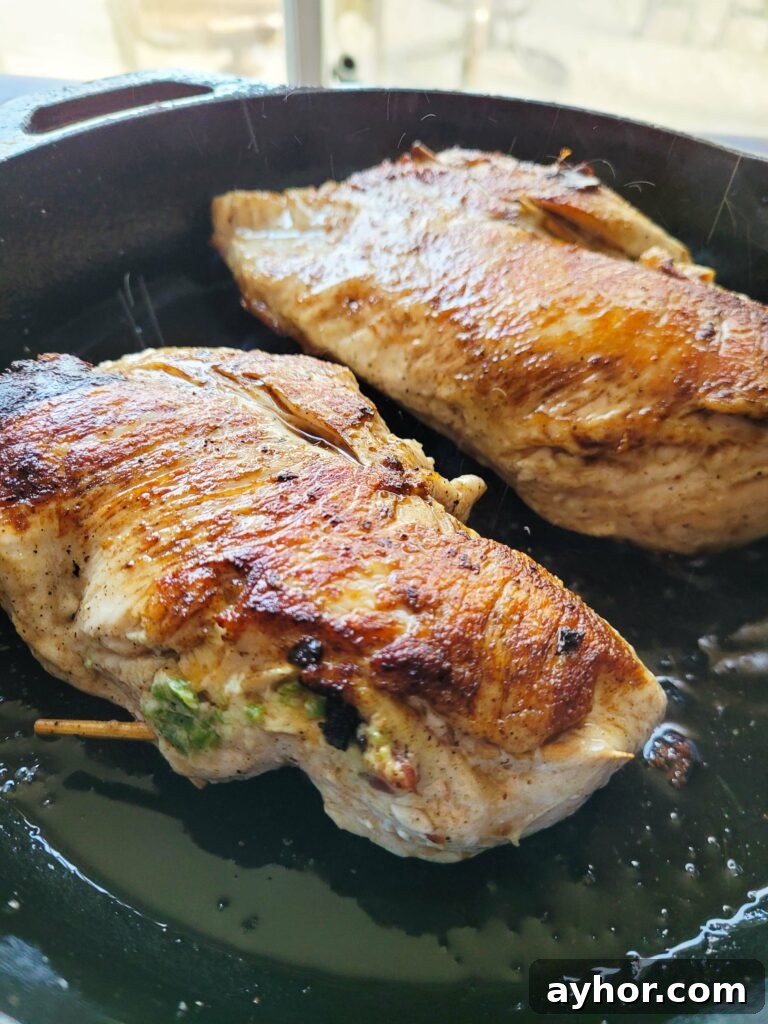 Jalapeño Popper Stuffed Chicken Breast with Creamy Cheese Filling 8 seared chicken breasts in a pan