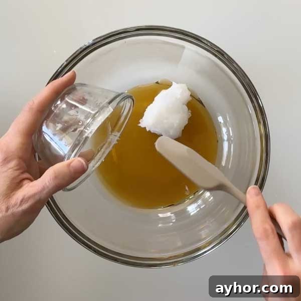 Adding the coconut oil to a glass mixing bowl.