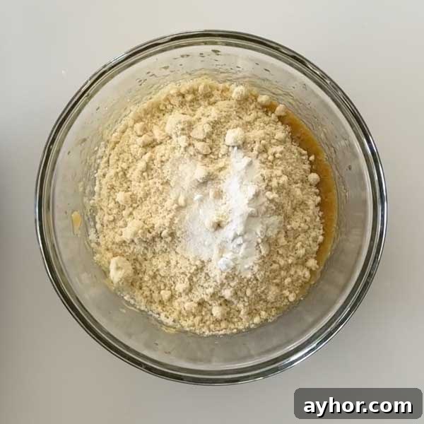 Adding dry ingredients to batter.