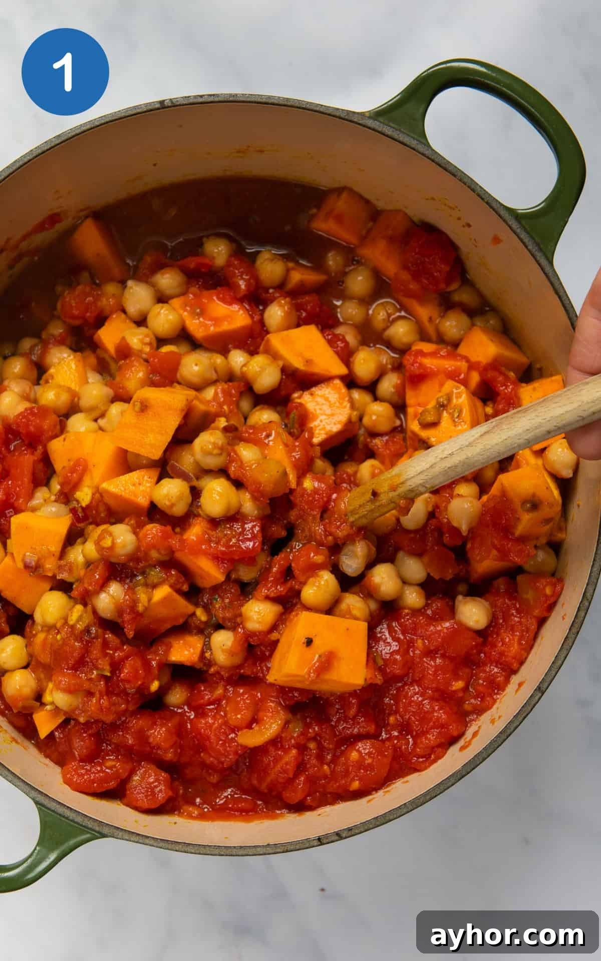 Sweet potato and seasonings combined in a pot.