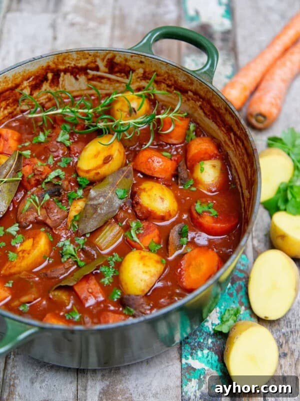 Hearty potato stew cooked in a green pot.