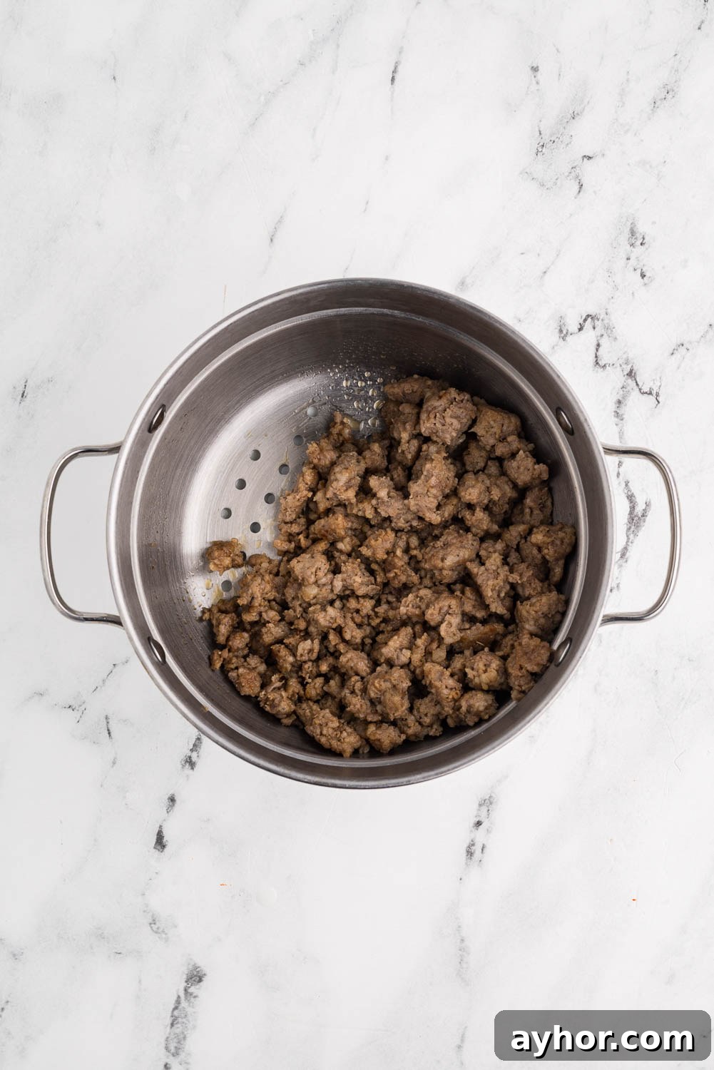 Browned sausage, broken into pieces, placed in a steamer basket