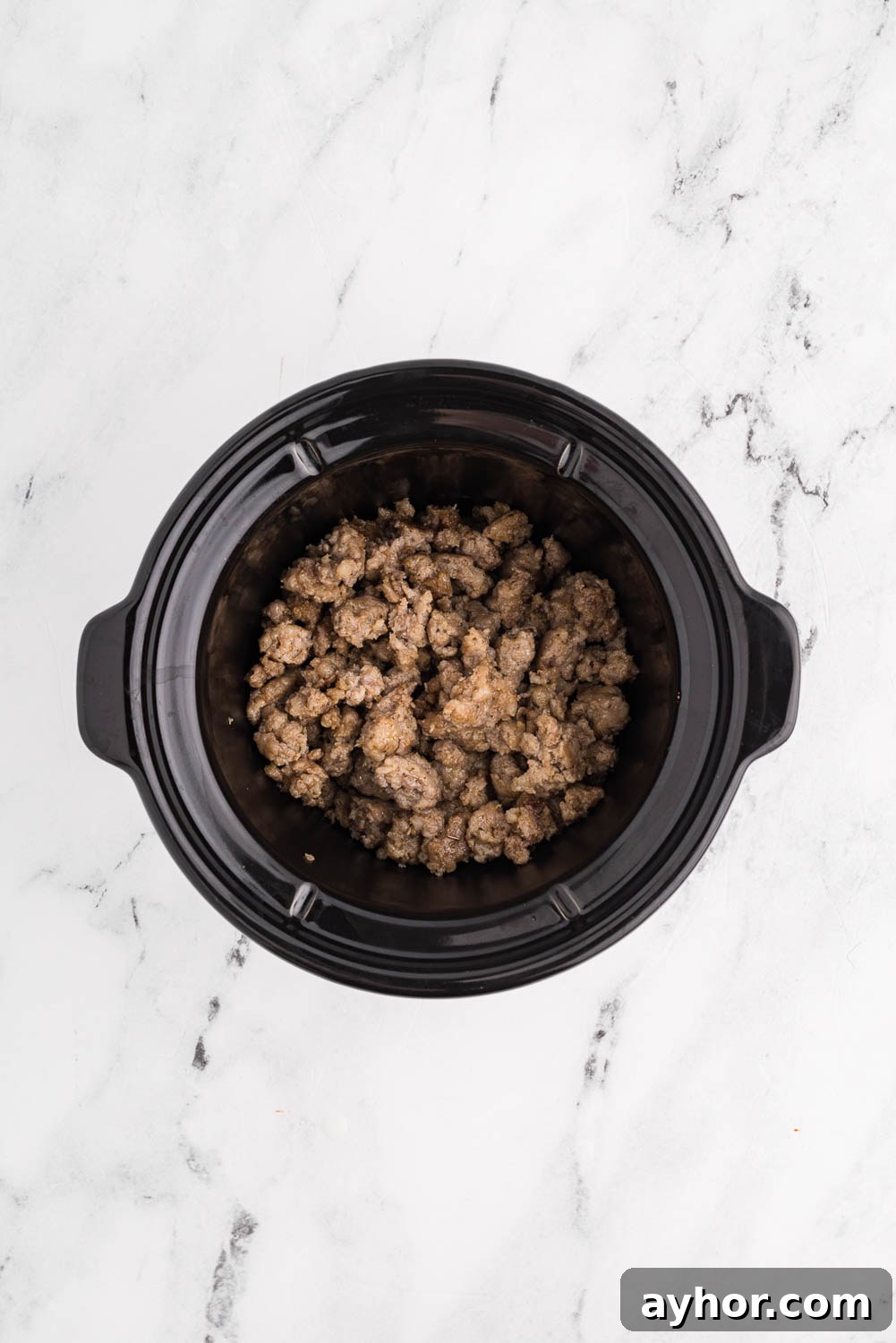 Browned Sausage broken up into pieces in slow cooker