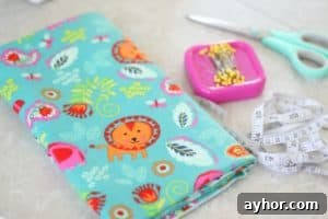 How to Sew a Bunk Bed Book Caddy: Step-by-Step Video Guide 6 folded fabric with pins, scissors and a measuring tape