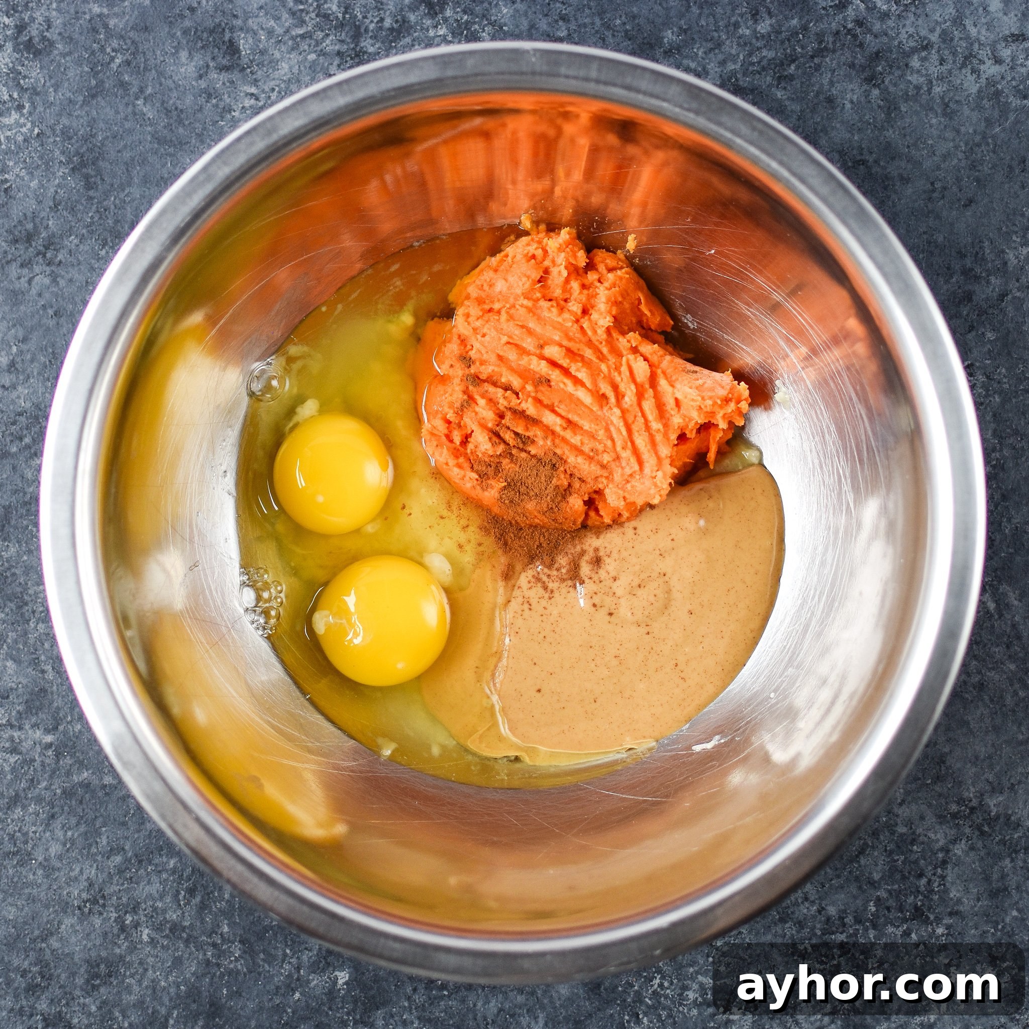 5-Ingredient Sweet Potato Banana Pancakes - Banana, sweet potato, nut butter, eggs and cinnamon are all you need to make these simple pancakes happen. Here are all the ingredients in a bowl ready to be mixed.