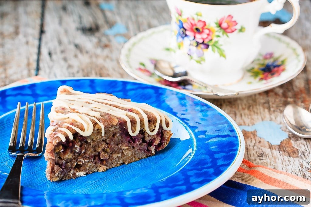 Banana Berry Oatmeal Cake - This banana berry oatmeal cake with a vanilla glaze is quick and easy to whip up, and makes a fantastic breakfast or a healthy snack!