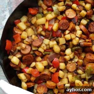 Cajun Potato Hash with Sausage and Peppers 5 spiced potato hash, sausage on skillet