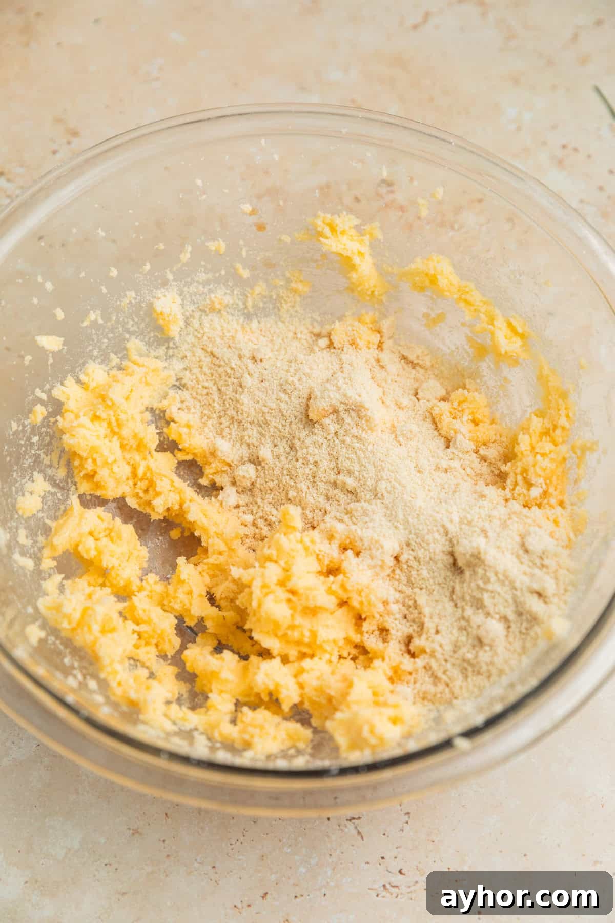 Almond flour added to bowl with creamed butter and sugar.